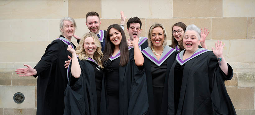 Group of UHI Inverness students smiling and waving to camera Group of UHI Inverness students smiling and waving to camera
