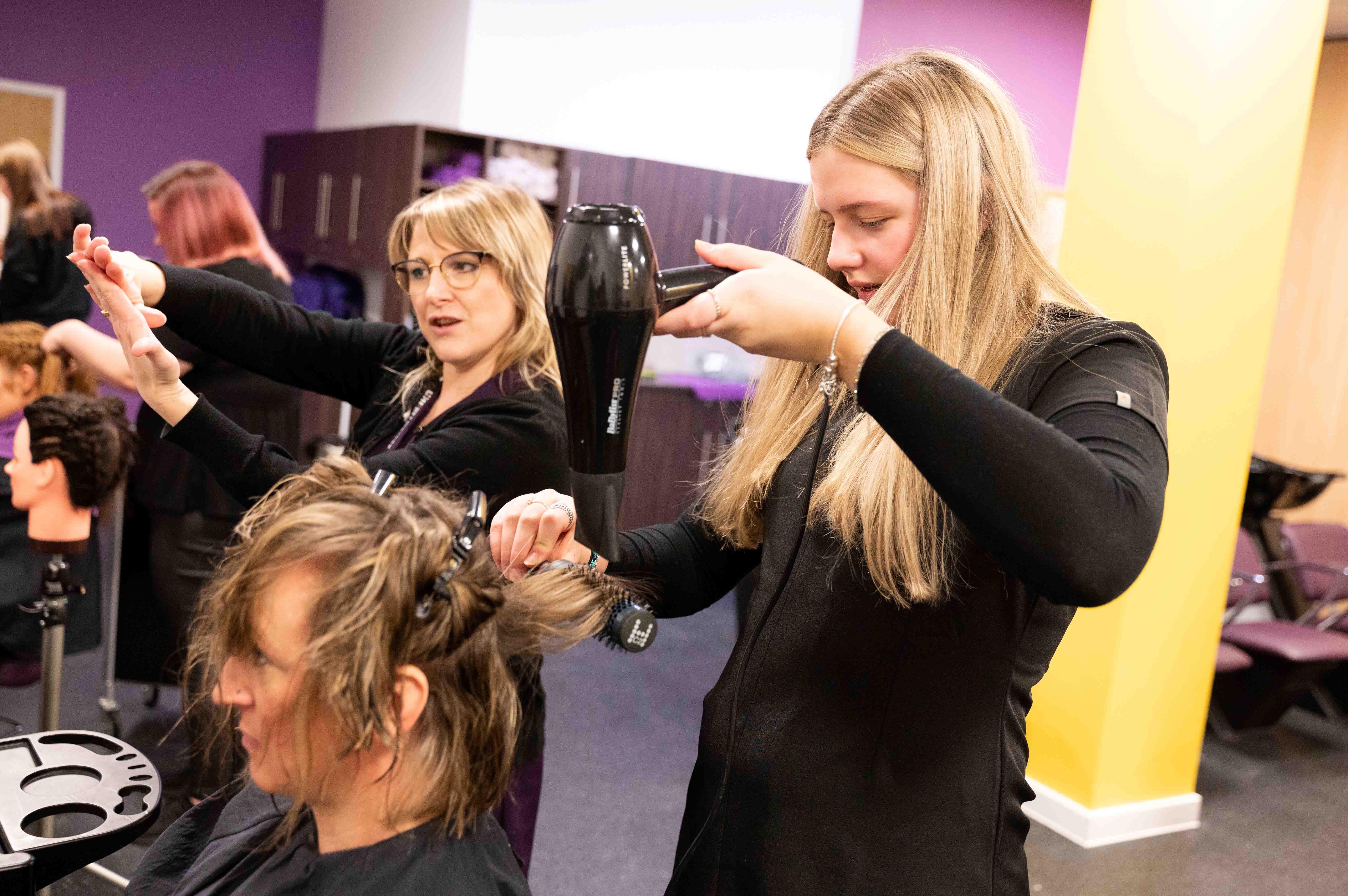 Student blow drying Student blow drying